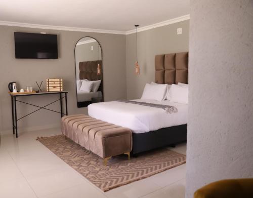 a bedroom with a bed and a large mirror at Amahle Guesthouse Bush in Dwarsloop