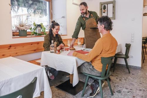 a group of people sitting at a table in a restaurant at Wolter Landhaus in Vipiteno