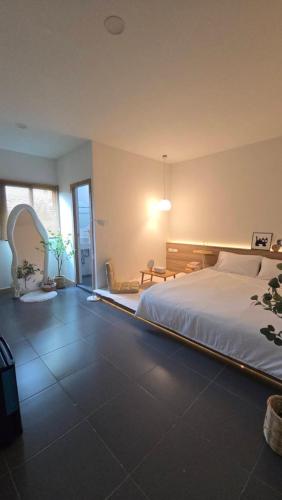 a bedroom with a large bed in a room at Sleep Owl Surat Thani in Surat Thani
