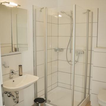 a white bathroom with a shower and a sink at Monte Baldo in Ilmmünster