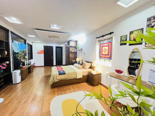 a bedroom with a bed and a couch at Kim's Home in Ba Dinh in Hanoi
