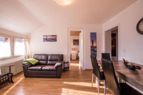 a living room with a couch and a table at Chalet Cecile in Interlaken