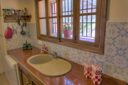 a kitchen counter with a sink and a window at La Galera Deià in Deia