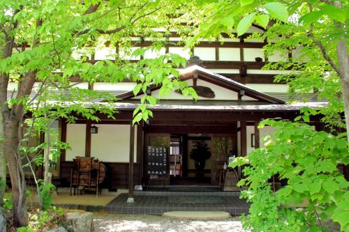 a front porch of a house with a table and chairs at Bunanoyado Koase in Aga