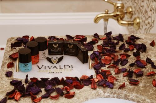 a bathroom sink with a bunch of flowers on a counter at Vivaldi Park Hotel in Ankara