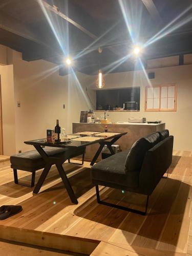 a room with a table and a couch and a kitchen at 陽月 Yo-Getsu in Yamaga