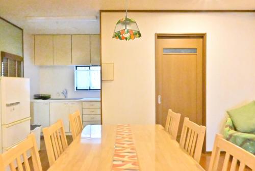 a kitchen and dining room with a table and chairs at Villa Izumi Eternity and a Day 一棟貸し民泊いずみの宿永遠と一日 in Izumi