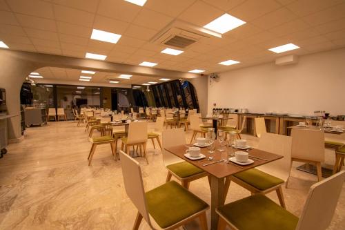 a dining room with tables and chairs in a room at Ekilibrio Hotel & Apart-Suites in Madrid