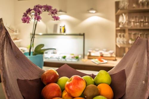 a bowl of fruit sitting on a table at RheinHotel ARTE in Remagen