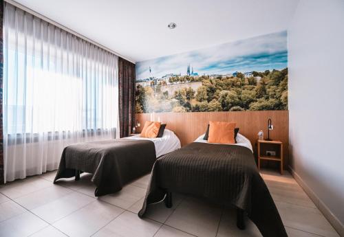 En eller flere senge i et værelse på Hotel Pax
