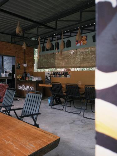 a waiting room with chairs and a table in a building at Laydaman Art Homestay in Ao Luk
