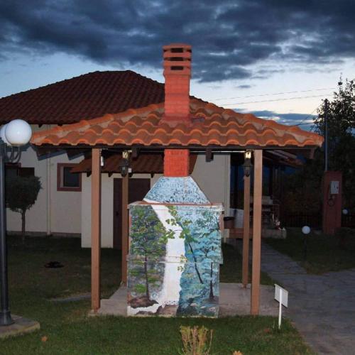 a painting of a house with a roof at Karyon Apartments in Kariófiton