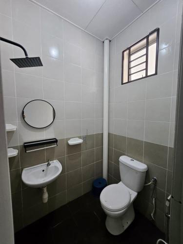 a bathroom with a toilet and a sink at Razumi's Homestay 2 in Arau