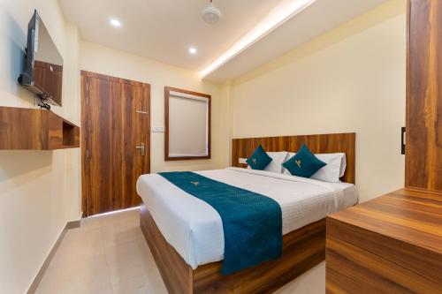 a bedroom with a large bed and a television at SAAD Residency in Cochin