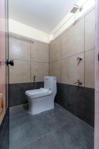 a bathroom with a toilet and a shower at SAAD Residency in Cochin