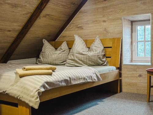 a bedroom with a bed with pillows on it at Penzion Festung in Petrovice