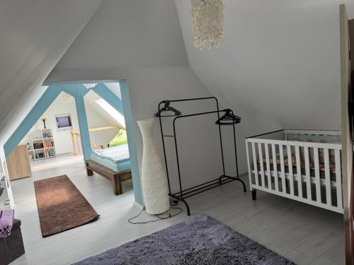a living room with a crib and a mirror at AlbLoft in Meßstetten