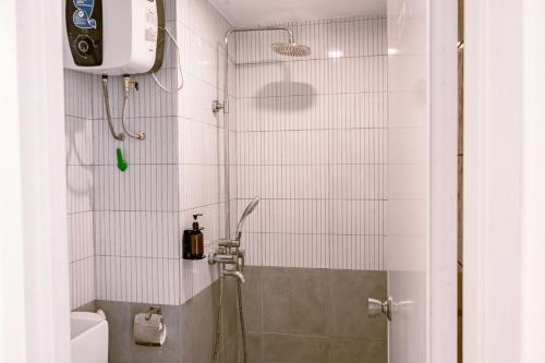 a small bathroom with a shower with a toilet at Orbit House in Bandung