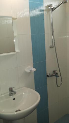 a bathroom with a sink and a shower at Guest House Margarita in Pomorie