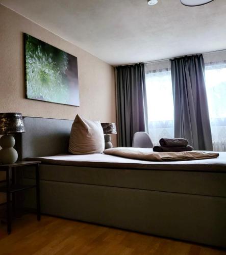 a large bed in a room with a window at Pension Restaurant Luna in Treis-Karden