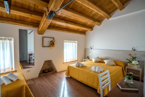 a large room with two beds and a table at Enoturismo Le Rampe in Vittorio Veneto
