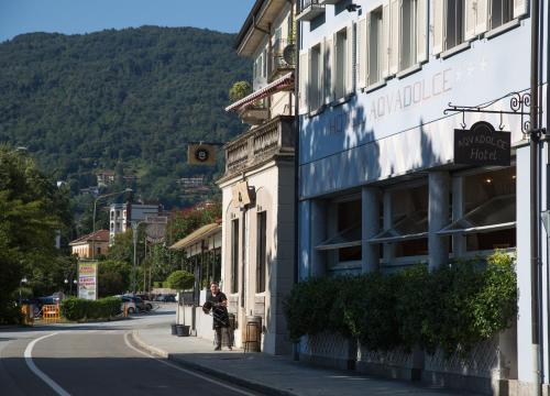 a person walking down a street next to a building at Hotel Aquadolce in Verbania
