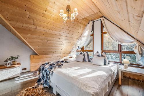 a bedroom with a bed in a wooden ceiling at ZRUB BINDT in Hnilčík