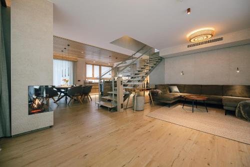 a living room with a staircase and a dining room at Insel der Sinne See-Chalets in Görlitz