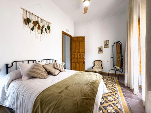 a bedroom with a large bed in a room at Almaterra Apartamentos Turísticos in Huéscar