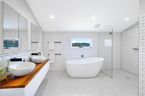 a white bathroom with two sinks and a tub at Kin Kin Farm House - Pets Allowed in Kin Kin