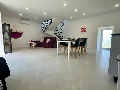 a living room and dining room with a table and chairs at Casa das Abelhas in Arcos de Valdevez