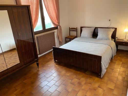 a bedroom with a bed and a large window at Chambre HABILIS 31 in Auterive