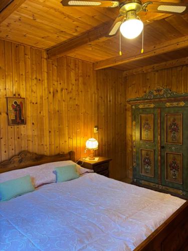 a bedroom with a large bed in a wooden room at Chata filozofa pod Policą in Skawica