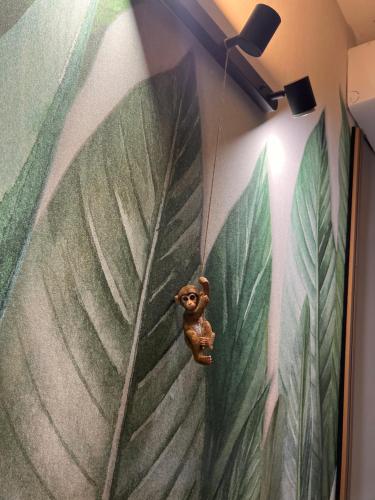 a toy dog hanging from a large leafy wall at LE TEMPLE DU LUXE in Agrigento