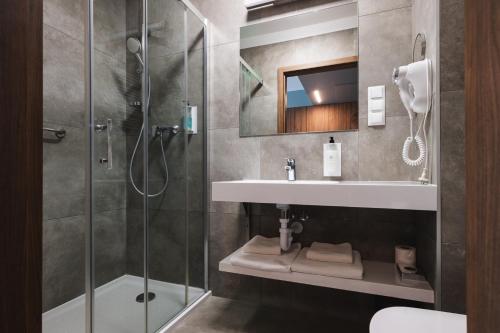 a bathroom with a sink and a shower at Focus Hotel Poznań in Poznań