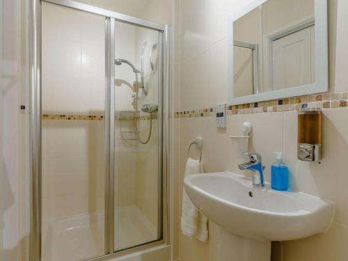 a bathroom with a sink and a shower at 4 Bed in Torpoint oc-89135 in Sheviock