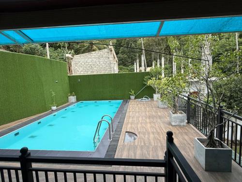 a large swimming pool on a balcony with at THARUMINI villa in Kandy