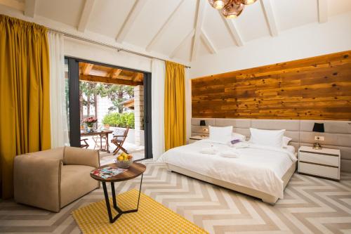 a bedroom with a bed and a chair and a table at Villa Diamond in Mlini