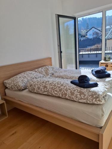a bedroom with a bed with two blue towels on it at Penthouse mit Seeblick & Terrasse Top 7 in Reifnitz