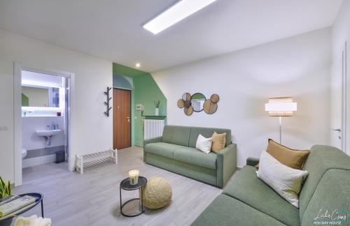 a living room with a couch and a table at Daniel House - Lake and ferry terminal 1 minute walk, in the heart of Bellano in Bellano