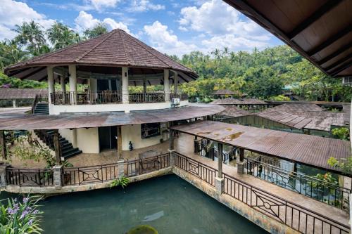 an aerial view of a house with a pool of water at Kamayan sa Palaisdaan Hotel and Resort Quezon in Lucban