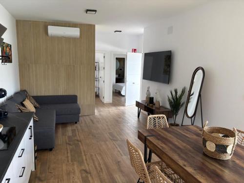 a living room with a couch and a table at GUACAMAYOS in Cádiz