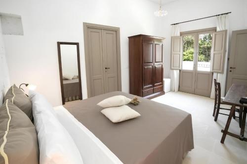 a bedroom with a bed with a couch and a mirror at Casa Frea Dimora Storica in Martano