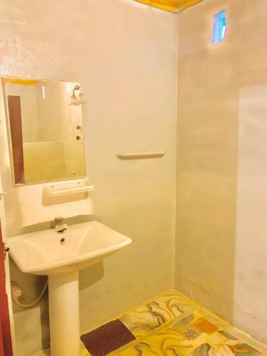 a bathroom with a sink and a mirror at Blue Vibe in Arugam Bay