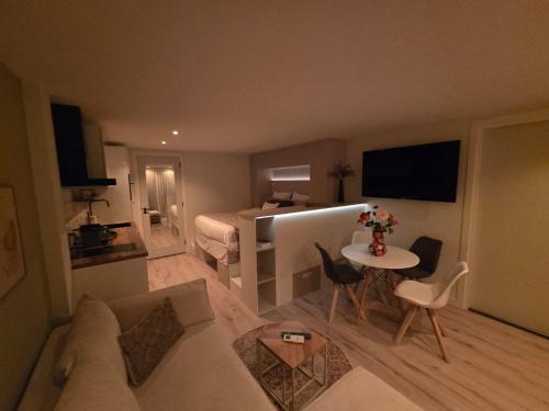a living room with a couch and a table at Huisje Sille - Private studio in Volendam in Volendam