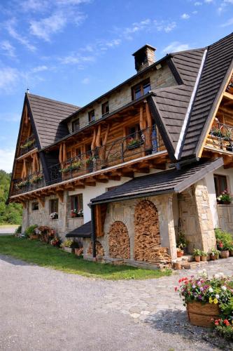 a large house with a gambrel roof at Apartmány Starý mlyn in Habovka