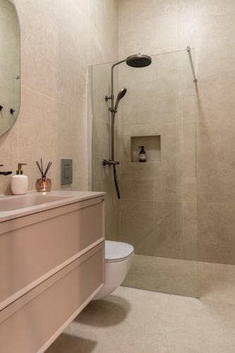 a bathroom with a shower and a toilet and a sink at Palmotić Heritage Suites - Main Square - FREE Parking in Zagreb