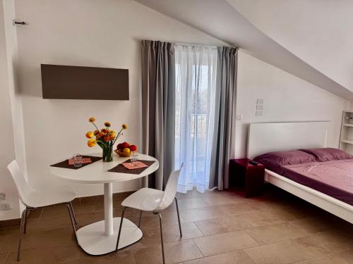 a bedroom with a bed and a table with flowers on it at MareVasto - appartamento Vasto Marina in Vasto