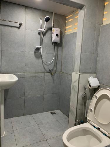 a bathroom with a shower with a toilet and a sink at Uncle Yo House in Phuket