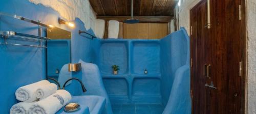 a blue bathroom with a blue tub with towels at Udaya Resort in Palakkad